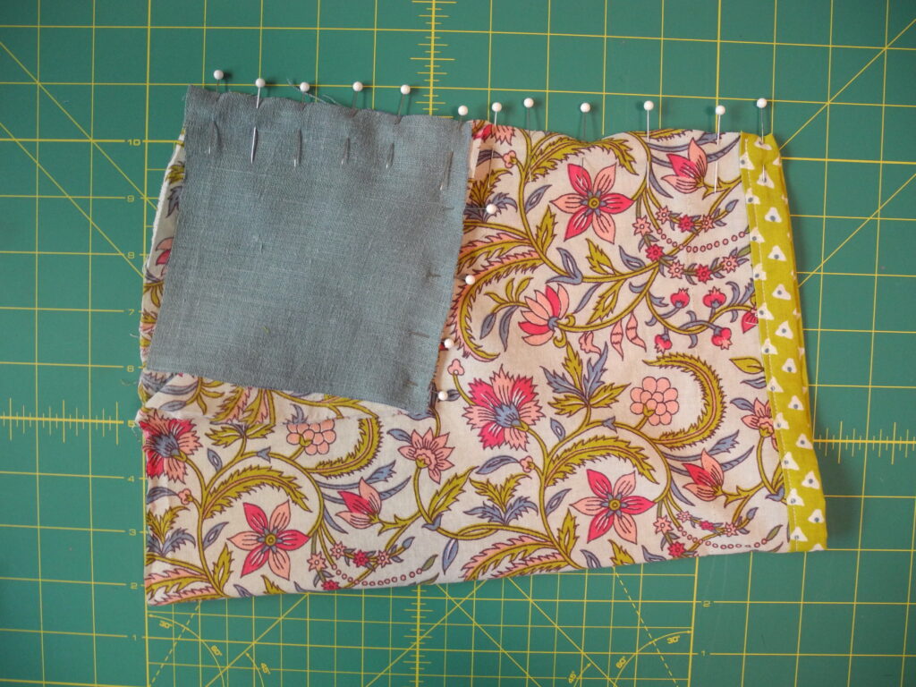 floral sleeve pinned with blue linen square to make underarm gusset