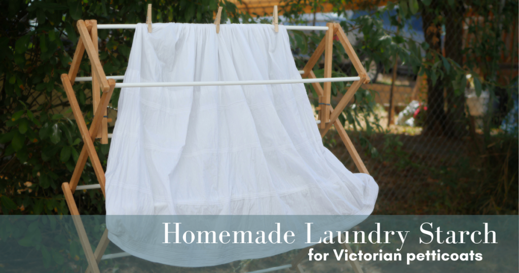 White corded petticoat hung outside to dry on a wood drying rack with three wood clothespins across the top. Text overlay reads homemade laundry starch for victorian petticoats. 