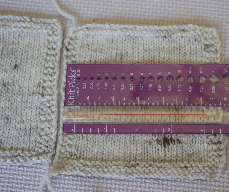 image shows a close up of a knitted swatch of light grey yarn with a purple knitting ruler laying over it to show the gauge. 