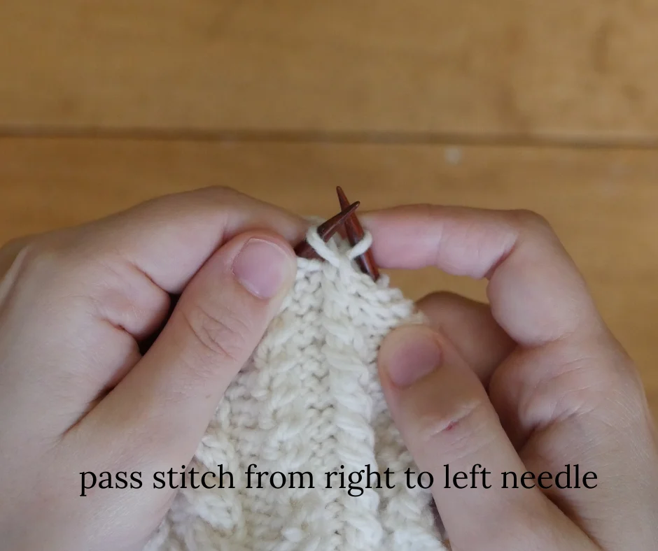 close up of dark wood knitting needles moving one stitch from the right needle to the left needle to complete the cable. Image is labeled pass stitch from right to left needle. 