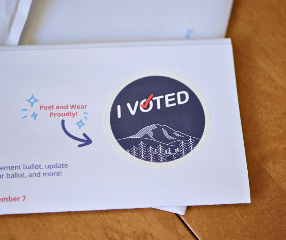 Image of an I voted sticker still attached to the mailer insert. 