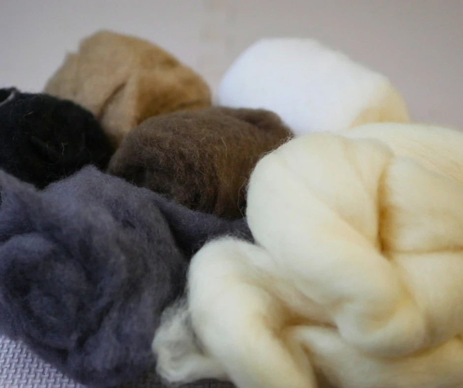 Image of felting wool in white, black, gray, and brown. 