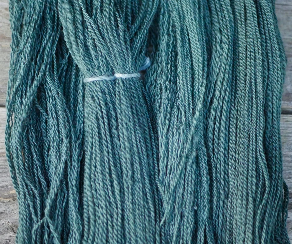 Image of green dyed hand spun yarn. 