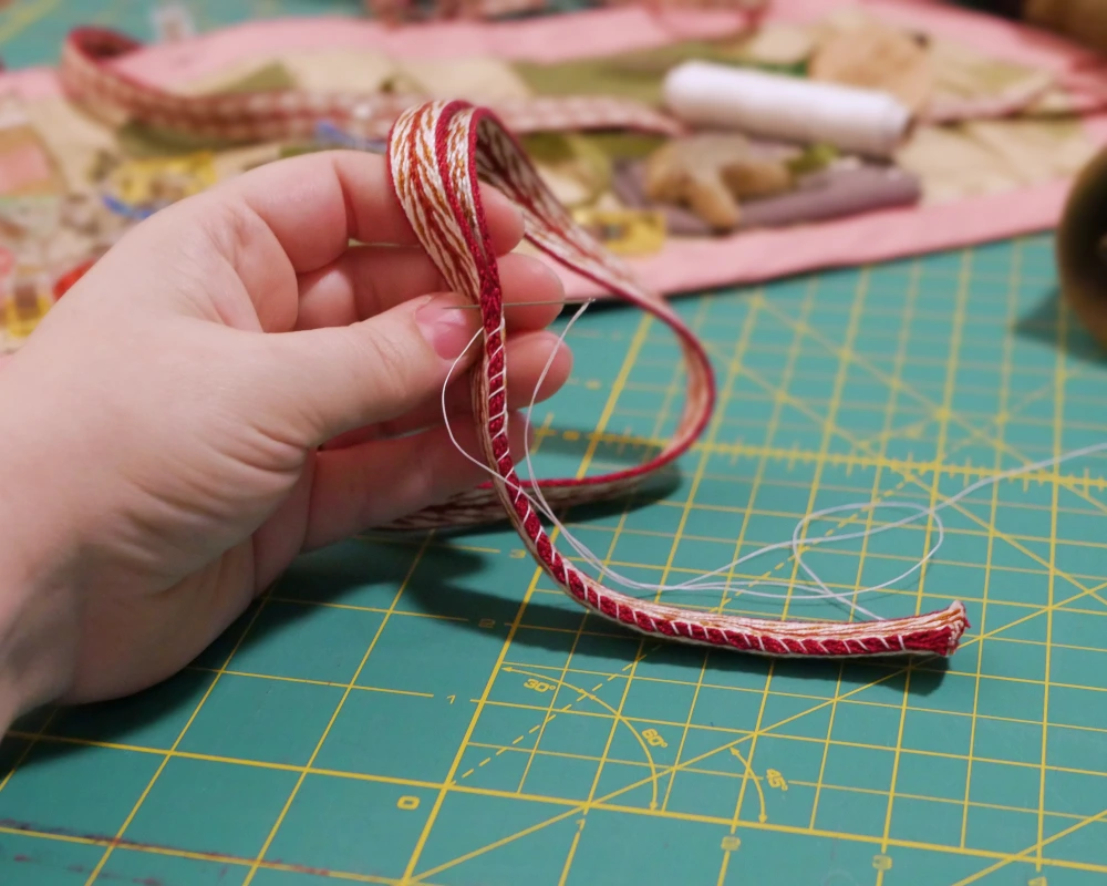 Trim for the shoulder straps is whipped stitched together along one set of edges. 